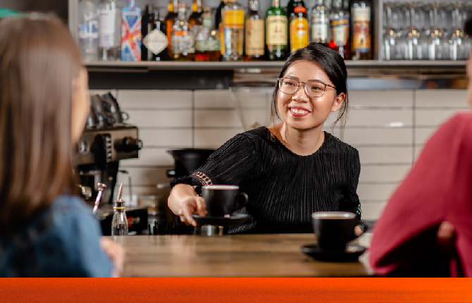 An international student working part-time at a cafe while she continues to study an Adelaide education provider