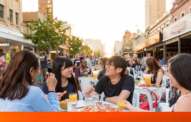 A group of international students enjoying an affordable meal in Adelaide